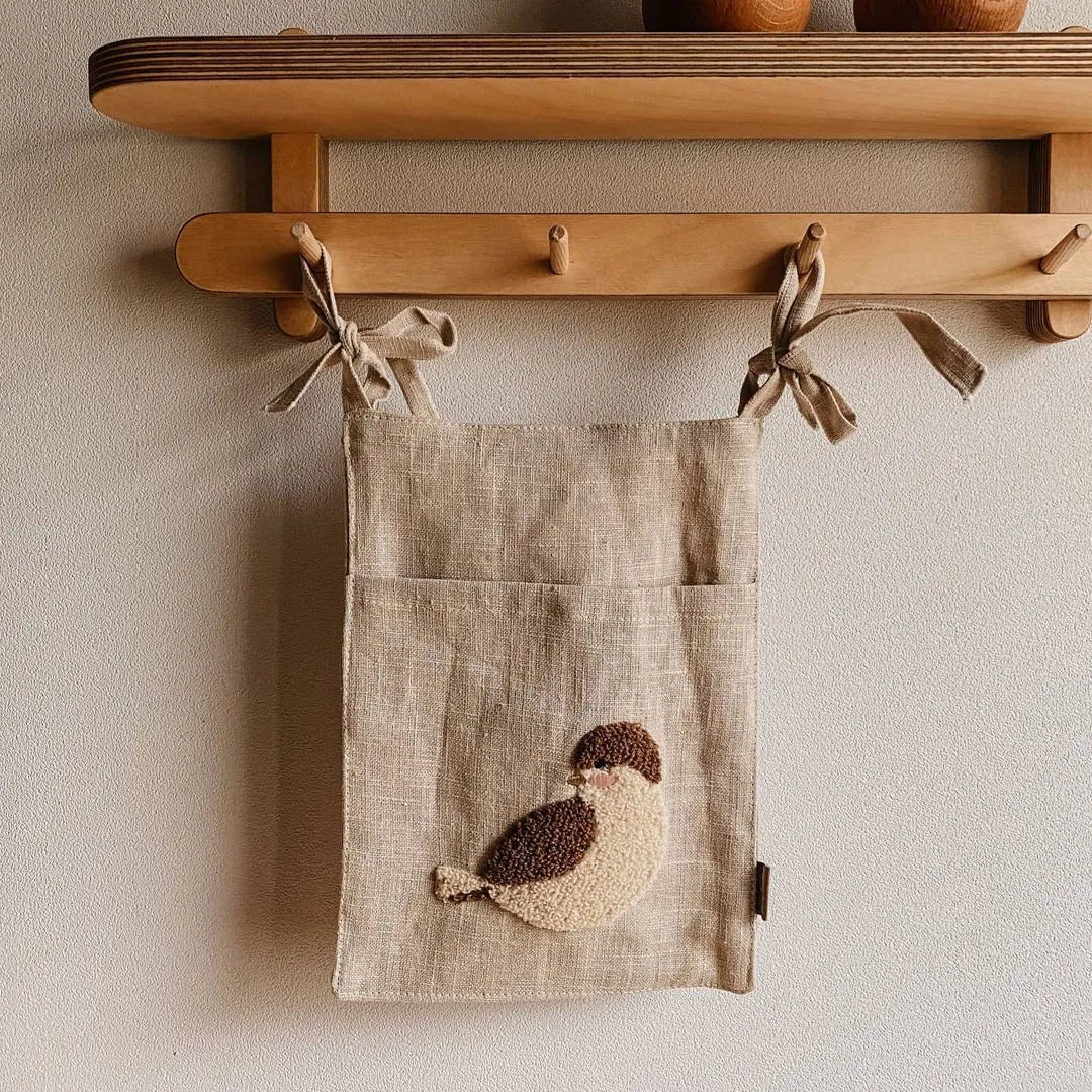 Khaki coloured cotton linen hanging storage bag with one pocket for bedside organisation