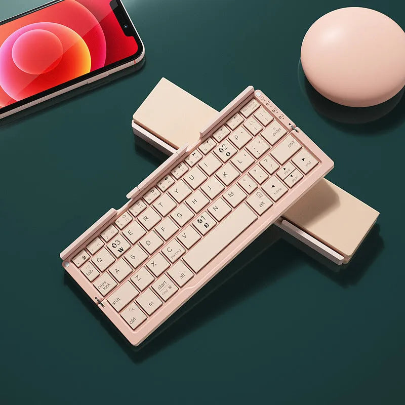 Aluminium folding Bluetooth keyboard with stand holding a smartphone