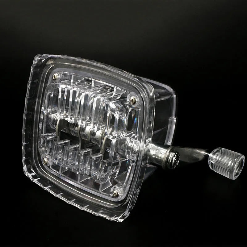 Manual ice crusher with transparent plastic body and stainless steel blade on a kitchen counter