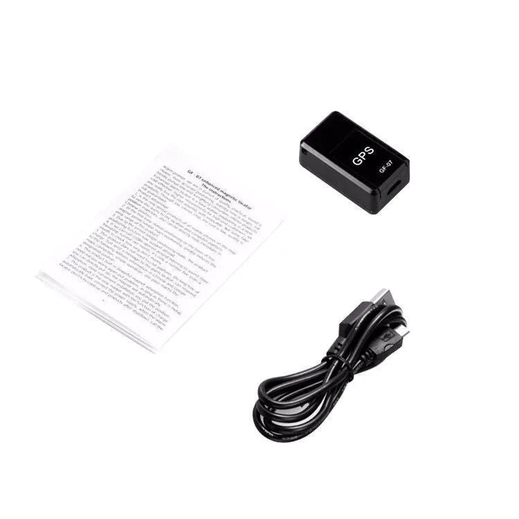 Small black magnetic GPS tracker device shown next to a USB charging cable.