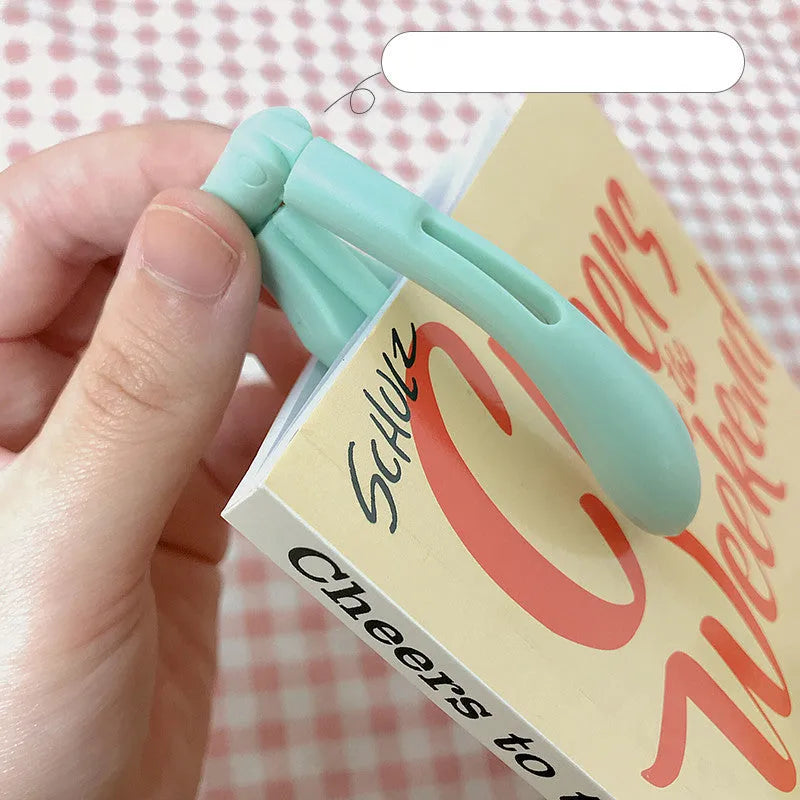 Folding book light in blue colour showing adjustable design for bedside reading
