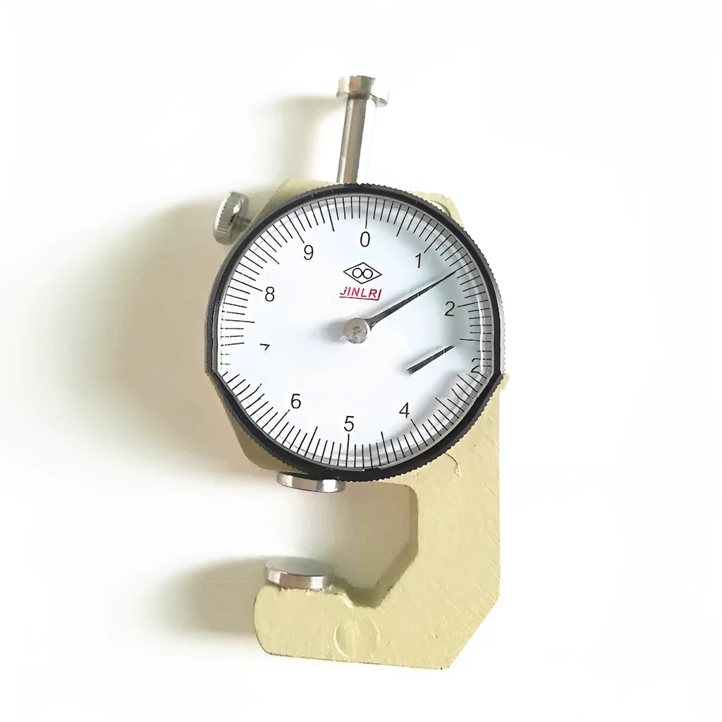 A film thickness gauge for measuring steel tubing, with scales showing 0-10mm and 0-20mm ranges.