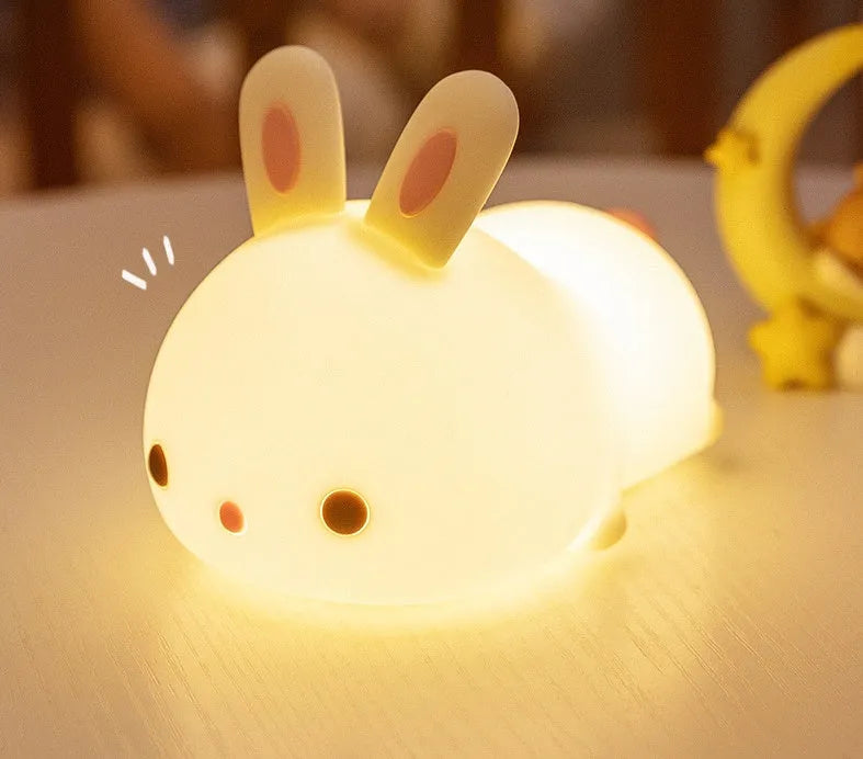 Rabbit silicone pat night light with seven-colour LED on a study desk