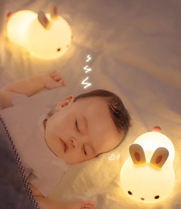 Rabbit silicone pat night light with seven-colour LED on a study desk