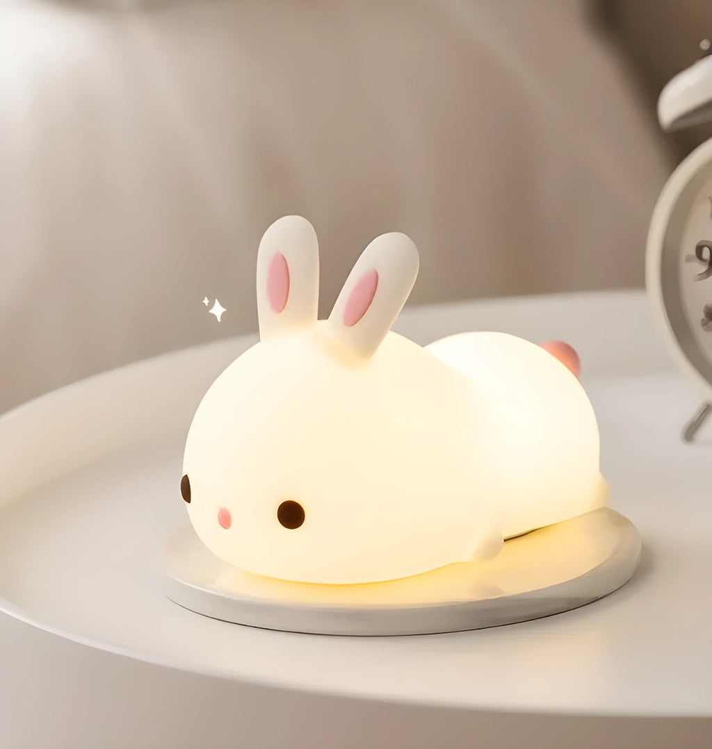 Rabbit silicone pat night light with seven-colour LED on a study desk