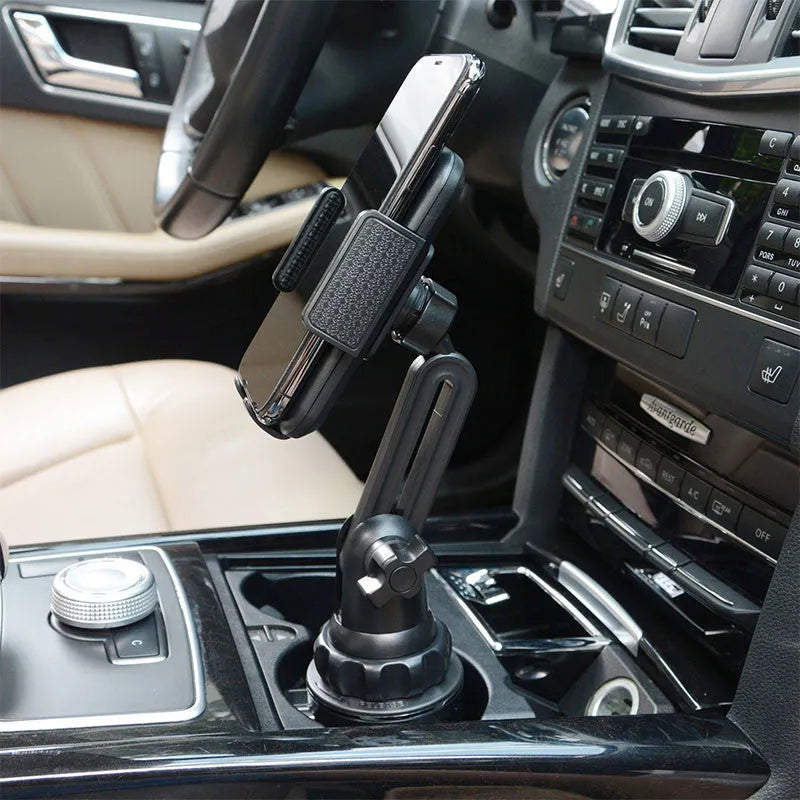 Black ABS car phone and tablet holder with 360-degree rotating head on a dashboard.