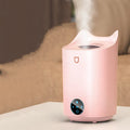 A coral pink and white USB-powered double spray humidifier and aroma diffuser on a table.