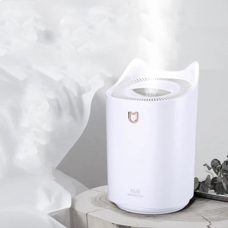 A coral pink and white USB-powered double spray humidifier and aroma diffuser on a table.