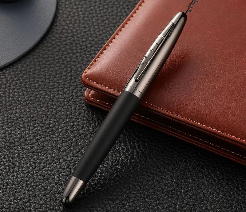 Heavy hand metal jewel signature pen with anti-slip grip on a desk, with blue refill visible
