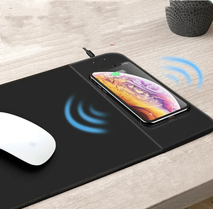 Cartoon wireless charging mouse pad with RGB lighting on a desk