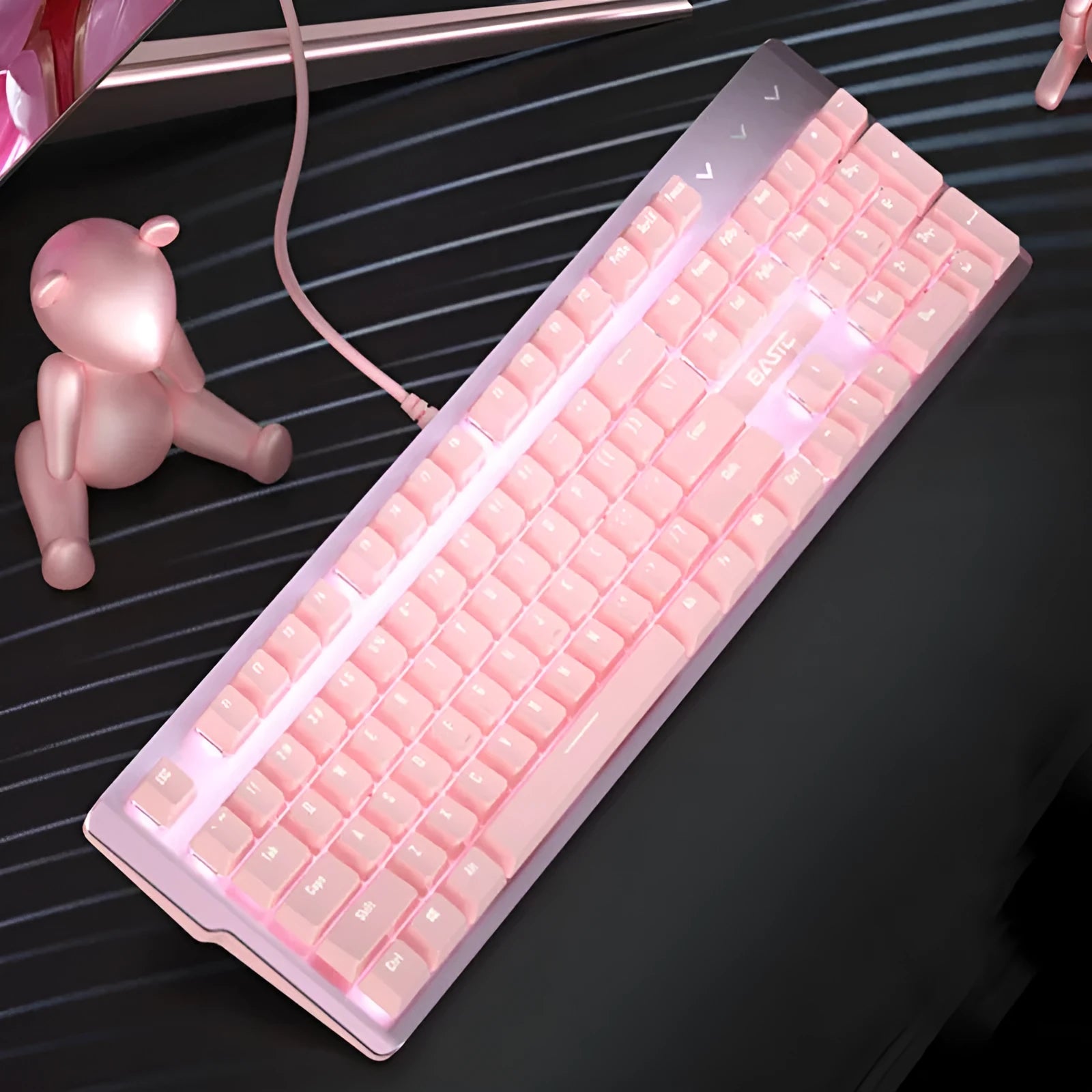 Pink mechanical gaming keyboard and wired mouse set on a desk.