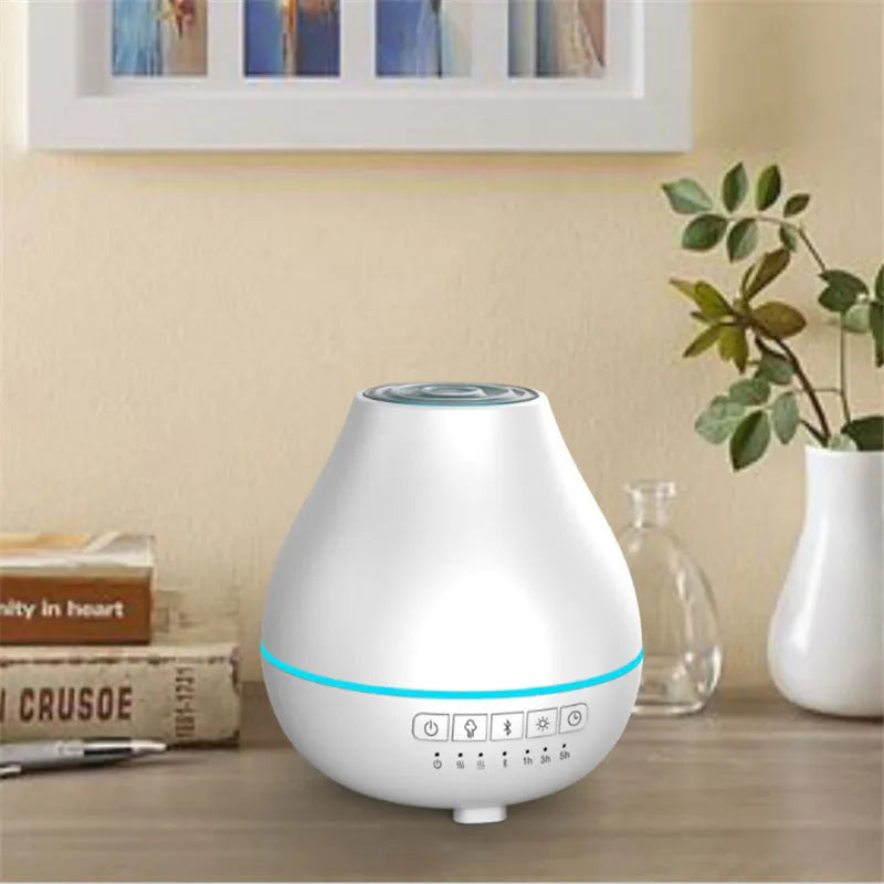 White round Bluetooth aroma diffuser and humidifier unit with night light on a wooden surface.