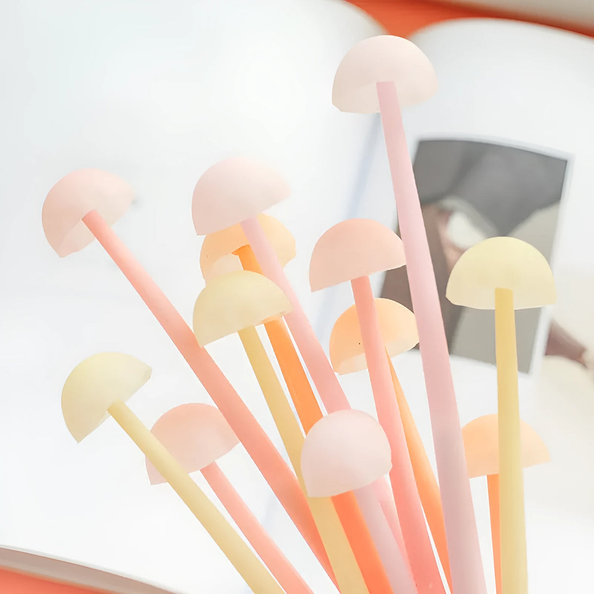 Luminous mushroom silicone gel pen in black with soft grip body and cartoon design on white background