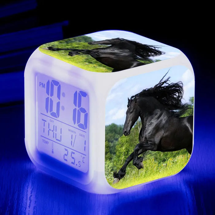 Square cartoon-style cube alarm clock with a colourful LED display showing time and temperature.