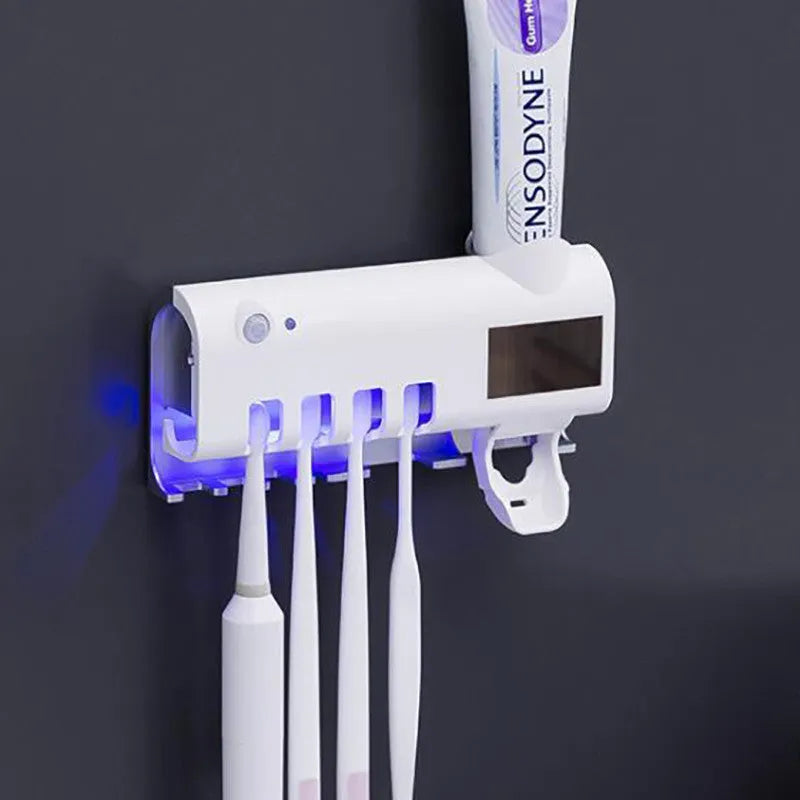 Black intelligent UV toothbrush steriliser with automatic toothpaste squeezer mounted on a bathroom wall.