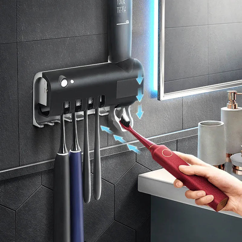 Black intelligent UV toothbrush steriliser with automatic toothpaste squeezer mounted on a bathroom wall.