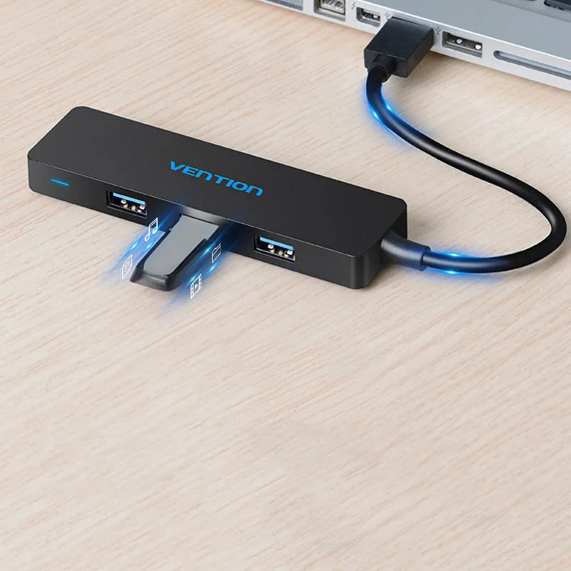 Black four-port USB 3.0 hub with a short cable for expanding laptop and computer connections