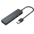 Black four-port USB 3.0 hub with a short cable for expanding laptop and computer connections