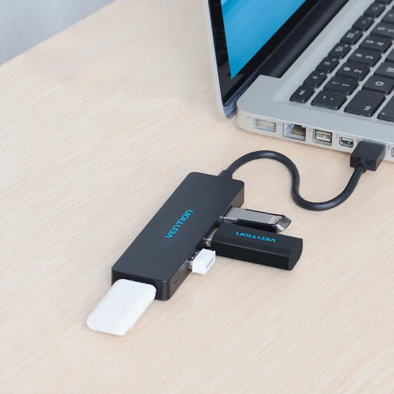 Black four-port USB 3.0 hub with a short cable for expanding laptop and computer connections
