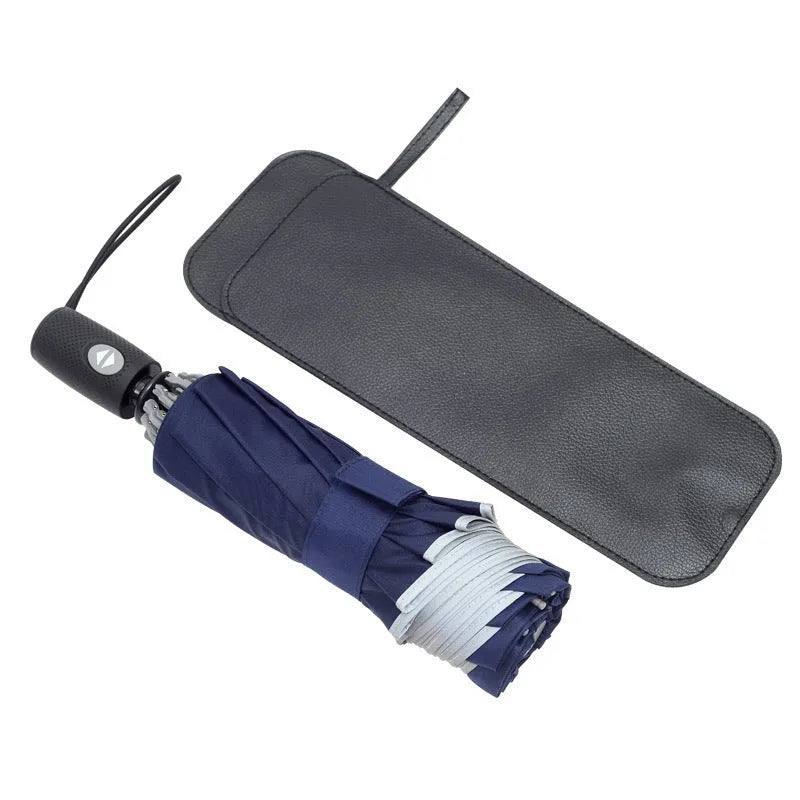 Black automatic reverse folding umbrella with plastic handle, shown closed and demonstrating the reverse mechanism.