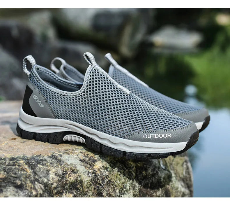 Breathable hollow mesh slip-on lazy shoes for men in black solid colour low-top design
