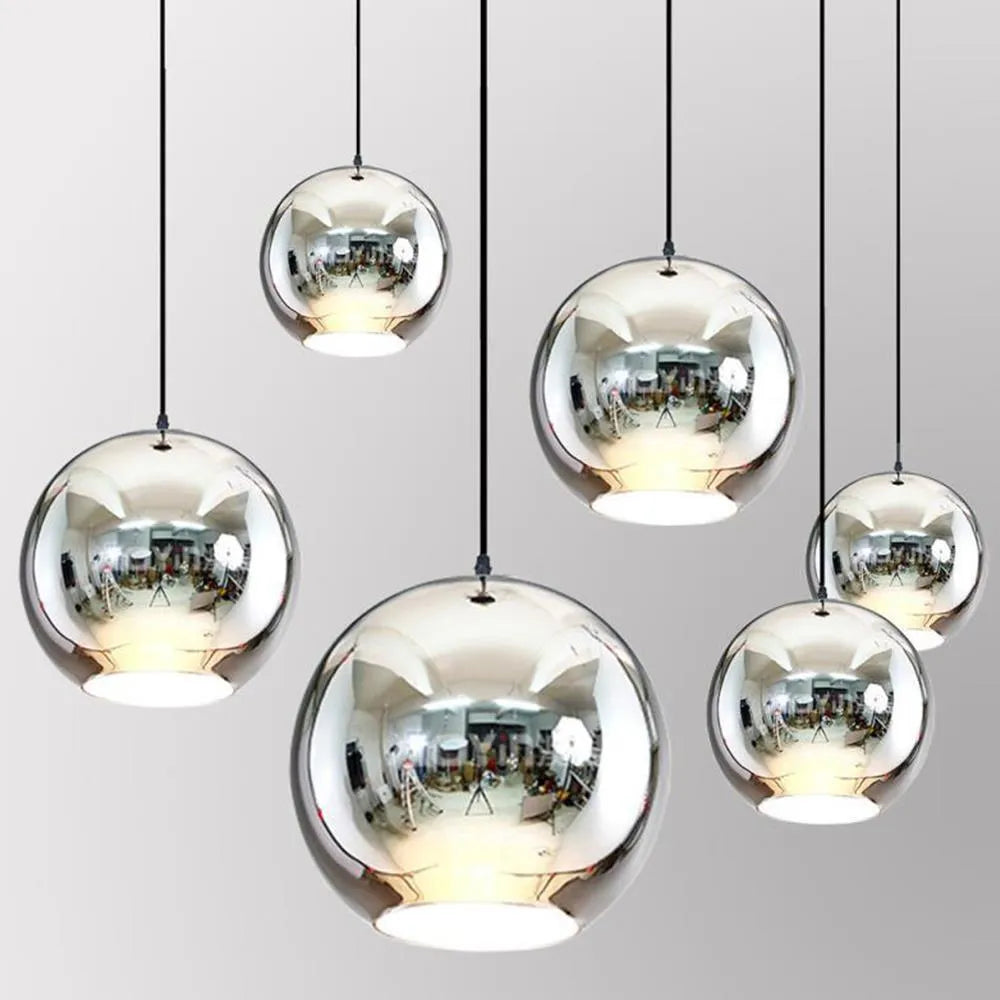 Close-up of a single-head glass chandelier with an electroplated metal body and adjustable chain.
