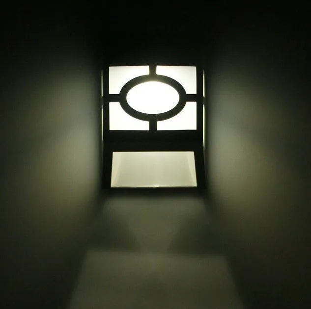 Retro-style white plastic solar wall light with two LEDs and a manual switch on the front.
