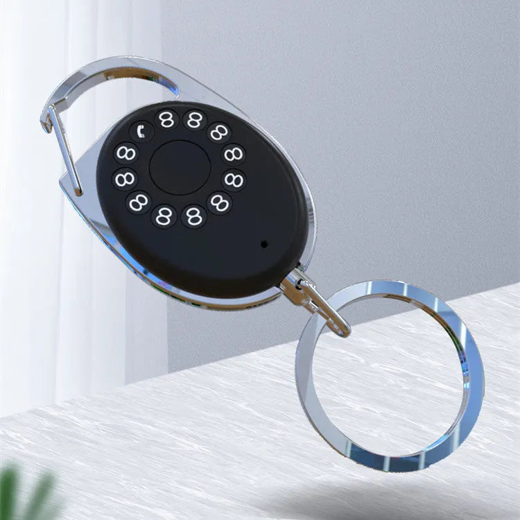 Black Bluetooth anti-lost tracker keychain with selfie function, shown next to keys for scale