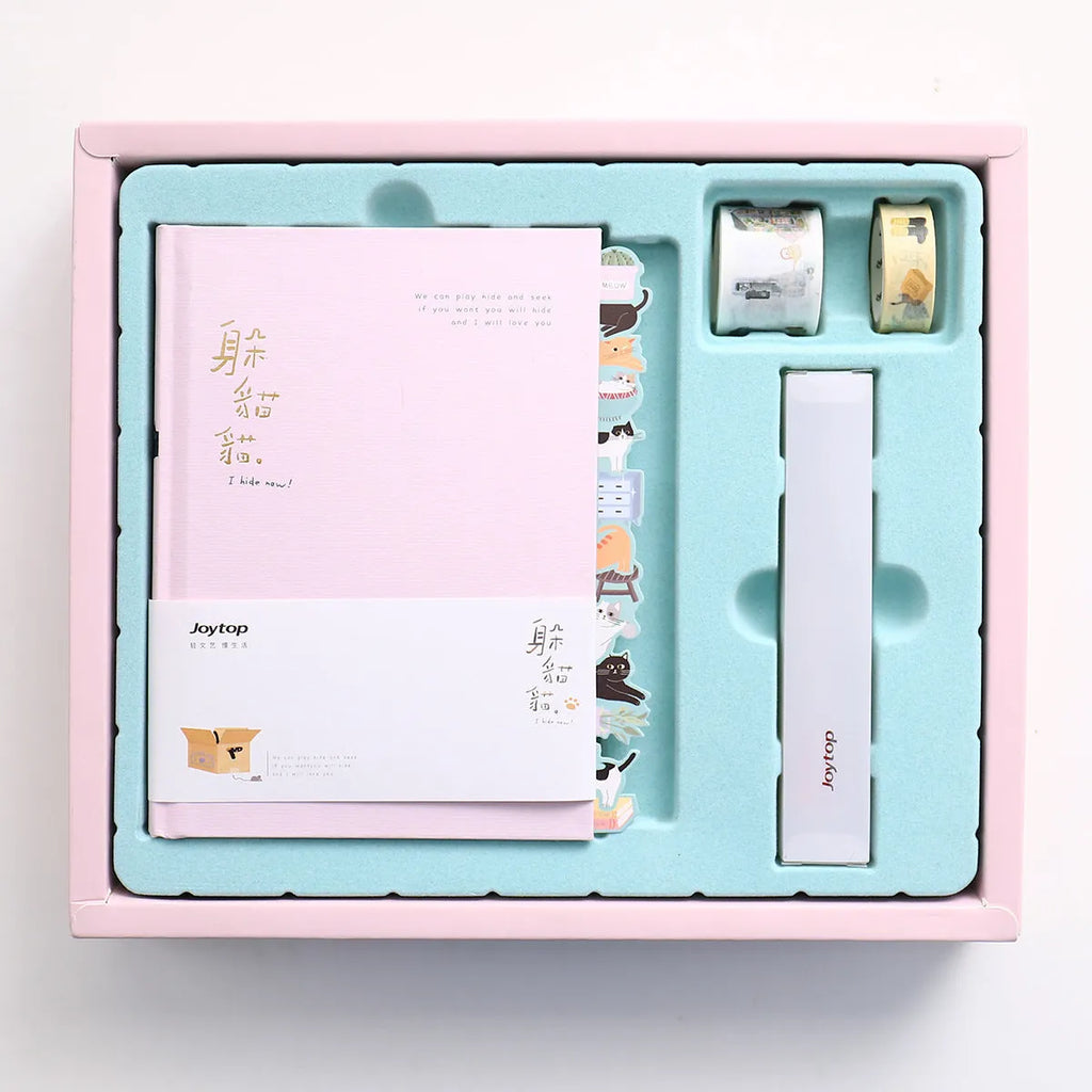 Peekaboo gift box hand ledger notebook in assorted colours, shown open with pen in holder, 13x18 cm size.