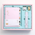 Peekaboo gift box hand ledger notebook in assorted colours, shown open with pen in holder, 13x18 cm size.