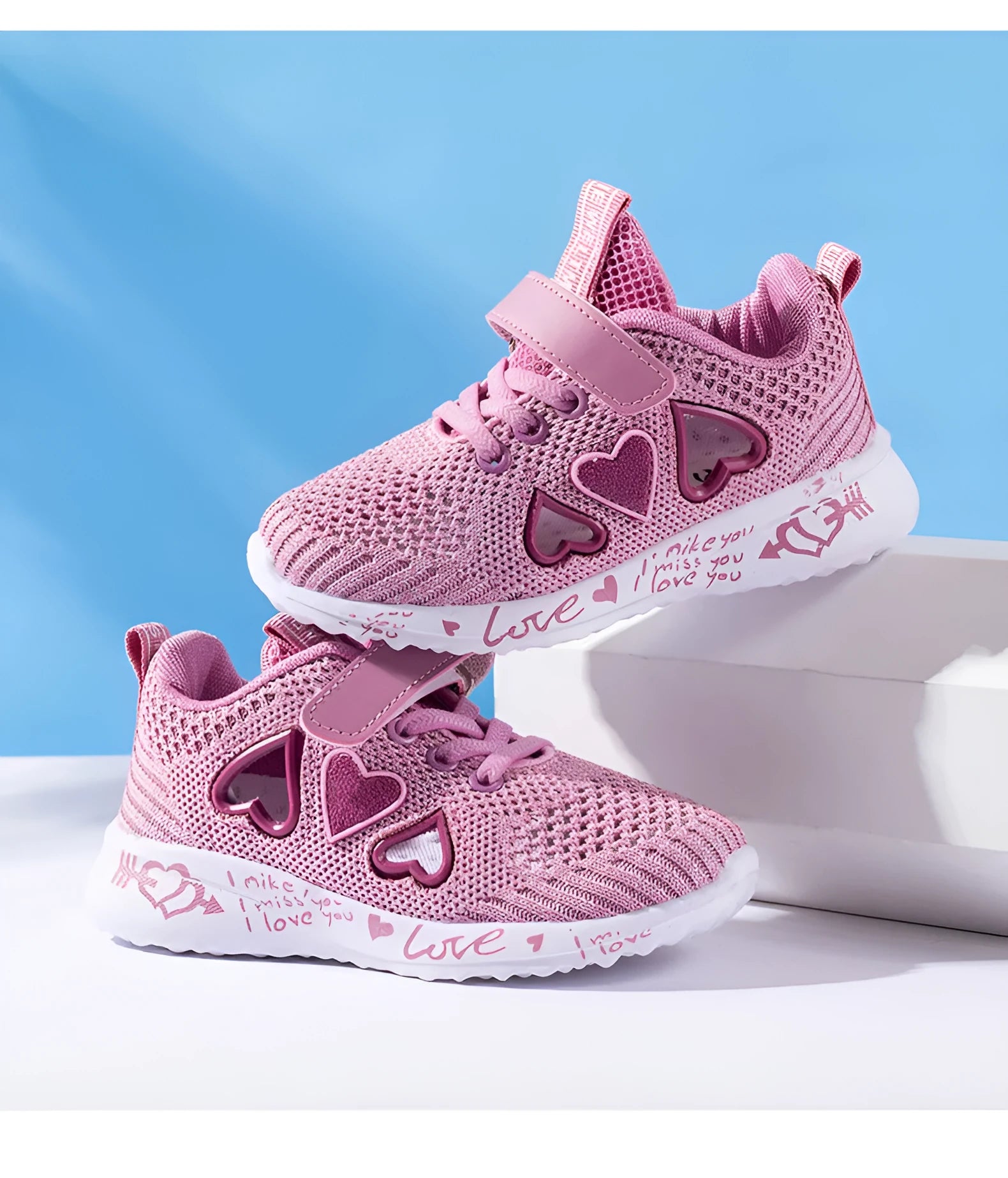 Children's pink and purple mesh sneakers with Velcro strap and cartoon pattern.