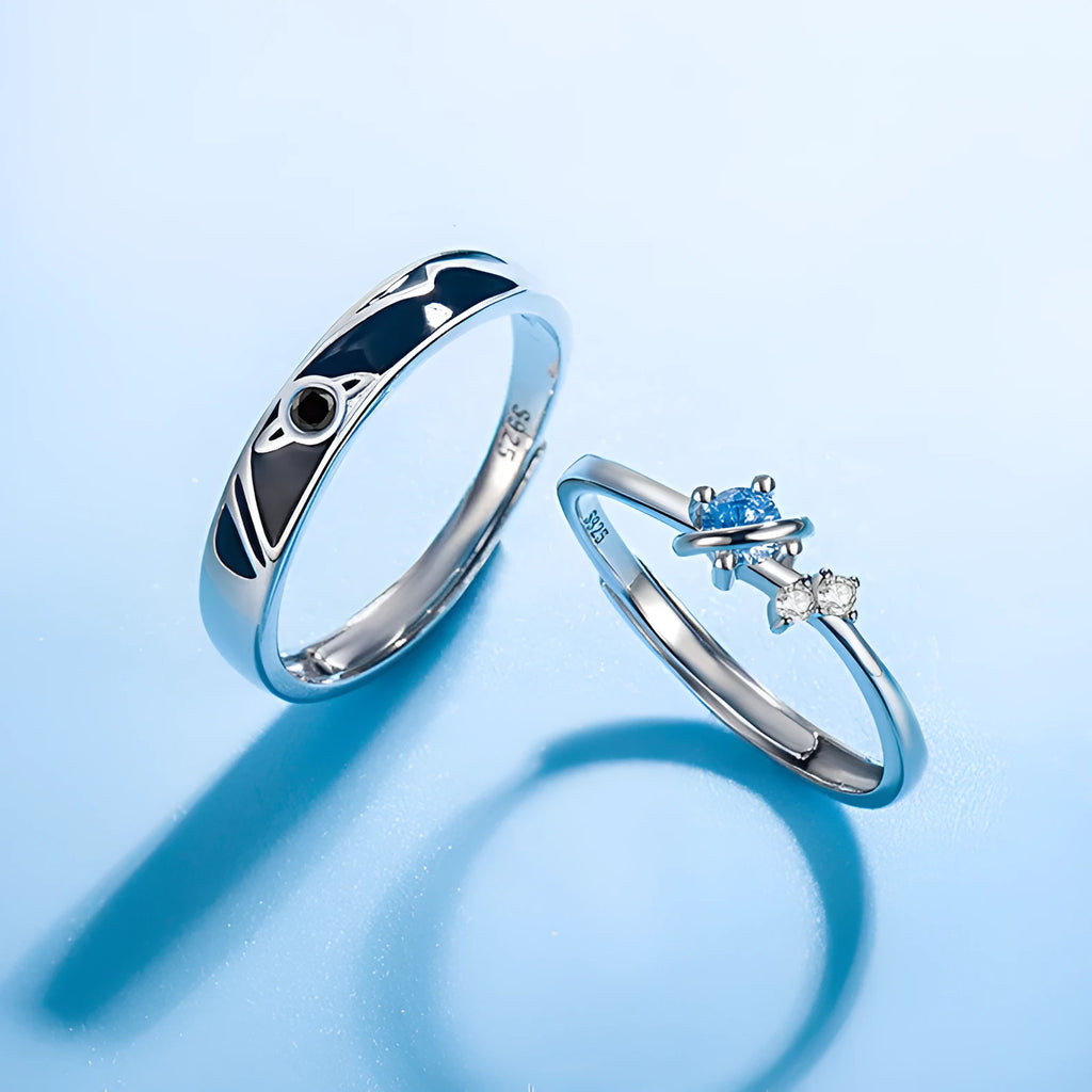 Dream Planet silver geometric couple rings with gem inlay on a flat surface