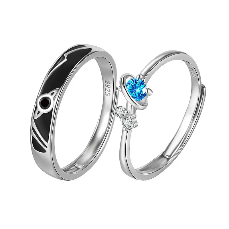 Dream Planet silver geometric couple rings with gem inlay on a flat surface