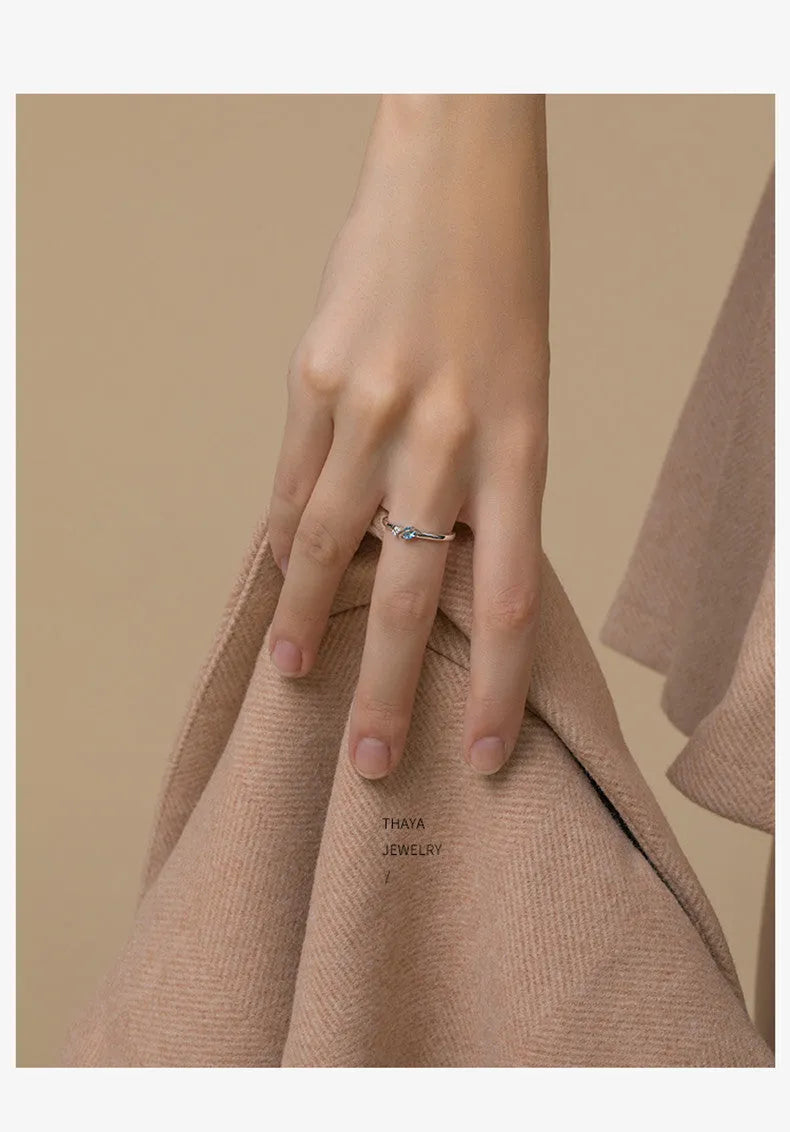 Dream Planet silver geometric couple rings with gem inlay on a flat surface