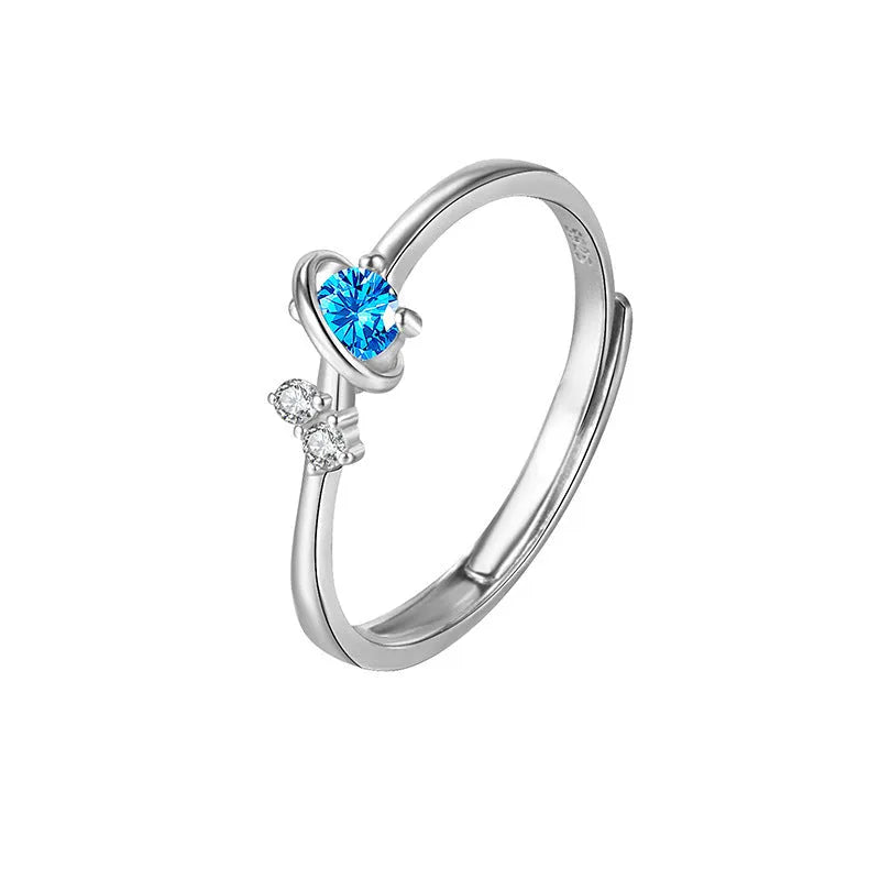 Dream Planet silver geometric couple rings with gem inlay on a flat surface