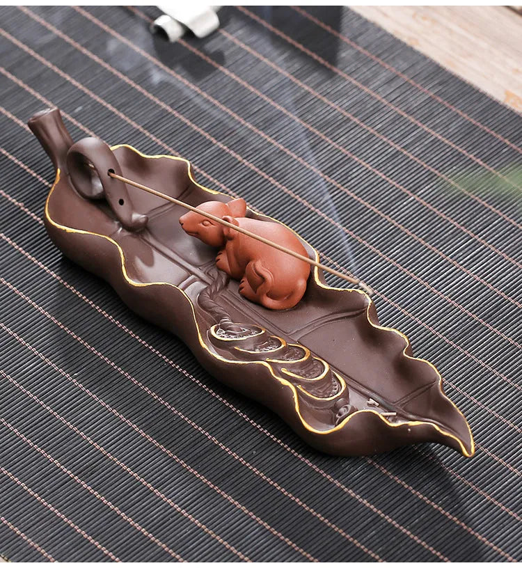 Purple clay ceramic lying incense burner with golden rat design for incense sticks