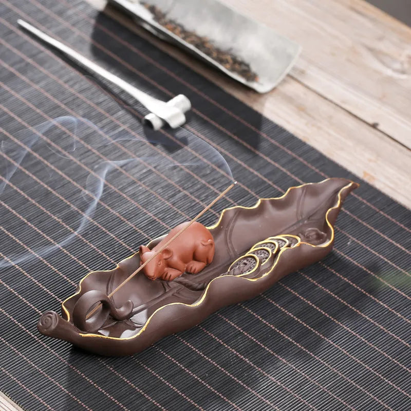 Purple clay ceramic lying incense burner with golden rat design for incense sticks