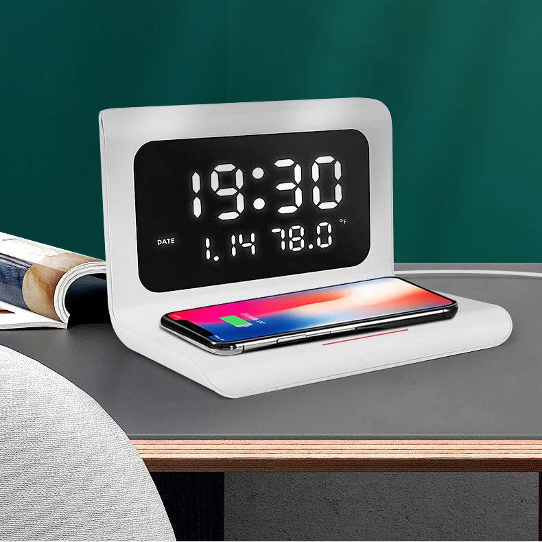 White wireless charger alarm clock showing time, date and temperature display with phone charging on surface