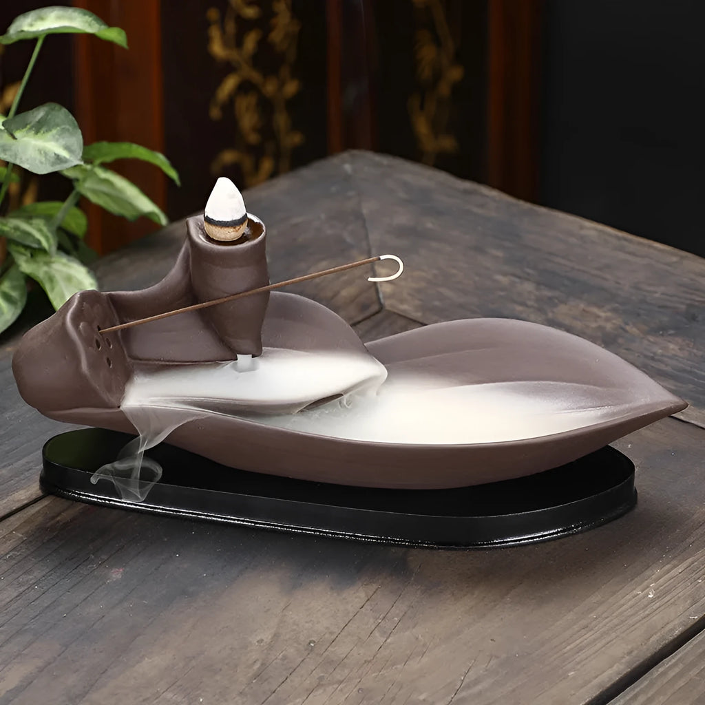 Brown purple sand backflow incense burner 21cm long on flat surface