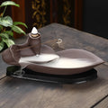 Brown purple sand backflow incense burner 21cm long on flat surface
