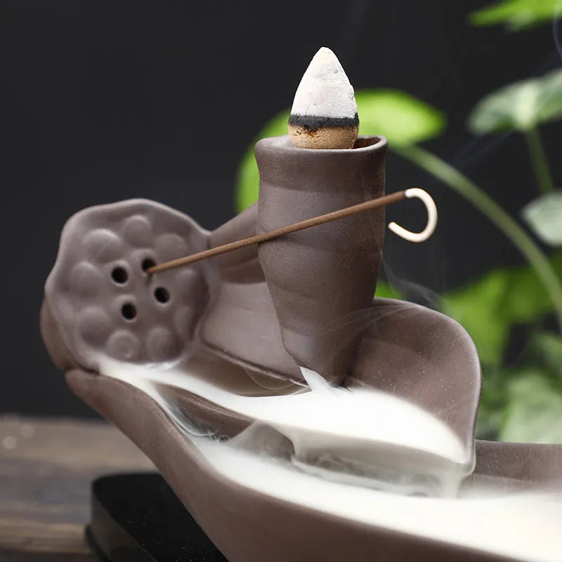 Brown purple sand backflow incense burner 21cm long on flat surface