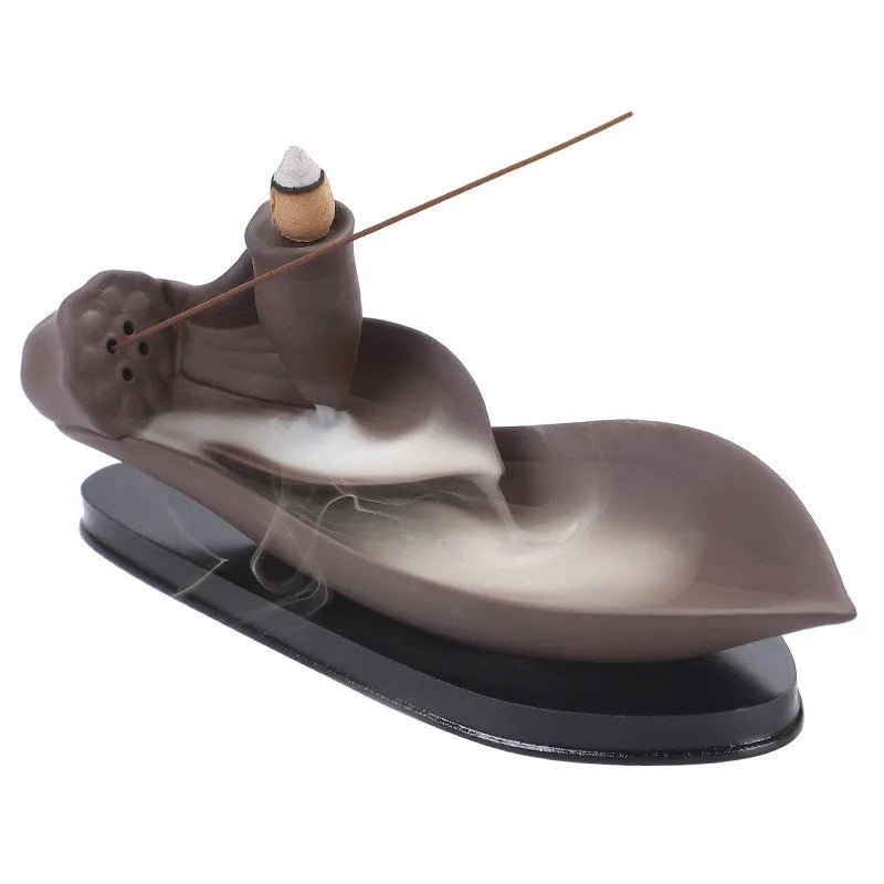 Brown purple sand backflow incense burner 21cm long on flat surface