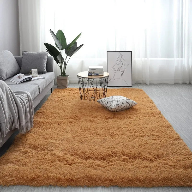Large rectangle fluffy plush carpet with anti-slip backing in a light grey colour on a wooden floor