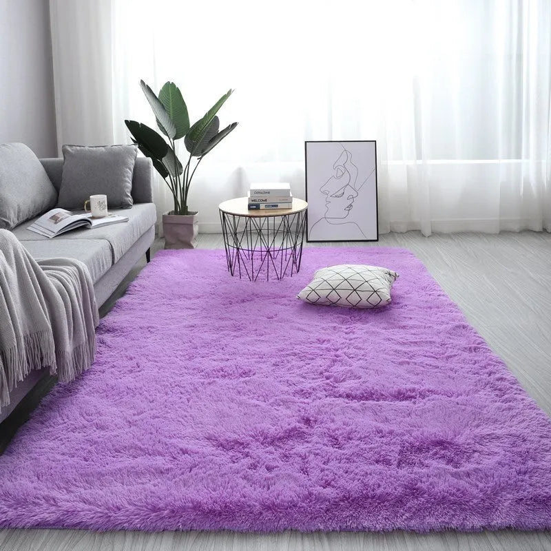 Large rectangle fluffy plush carpet with anti-slip backing in a light grey colour on a wooden floor