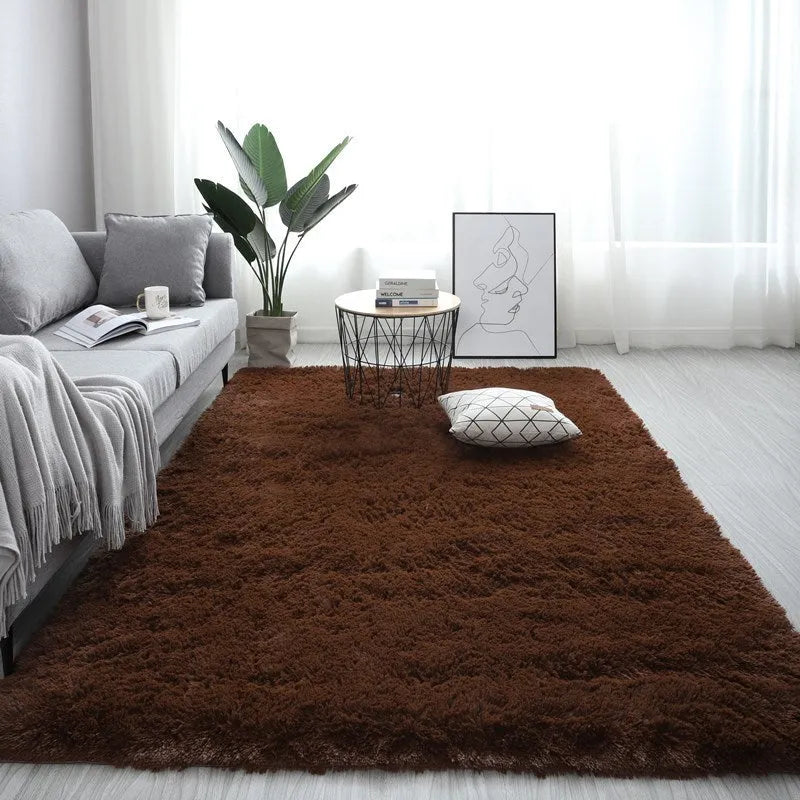 Large rectangle fluffy plush carpet with anti-slip backing in a light grey colour on a wooden floor