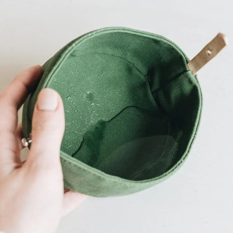 Waterproof foldable travel dog bowl in oil wax canvas, round shape, 150x75mm, shown in green or grey