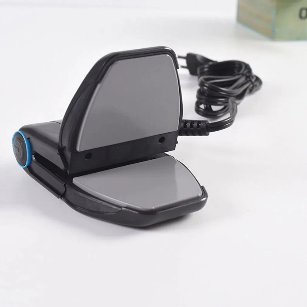 Small white portable handheld electric travel iron on a flat surface.