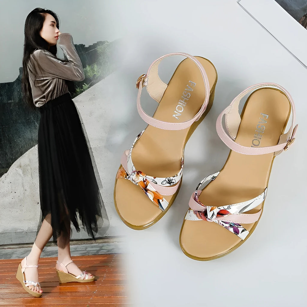 Women's pink wedge sandals with a thick heel, fish mouth design, and a buckle strap.