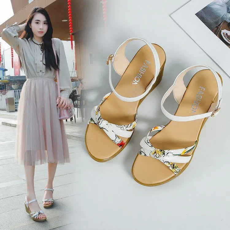 Women's pink wedge sandals with a thick heel, fish mouth design, and a buckle strap.