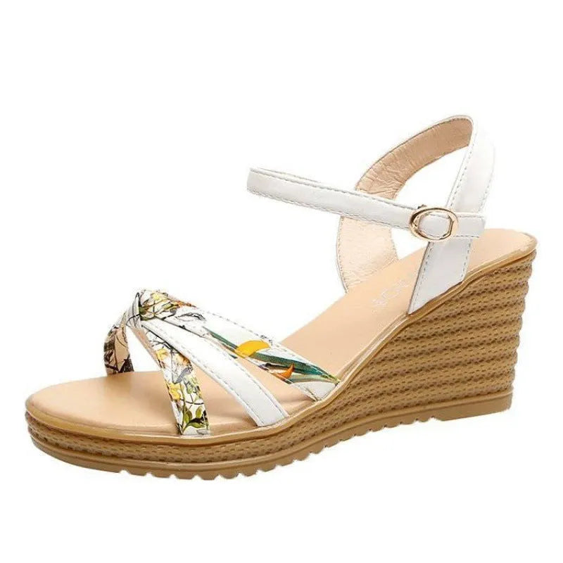 Women's pink wedge sandals with a thick heel, fish mouth design, and a buckle strap.